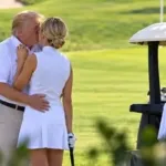 Donald Trump and Natalie Harp sharing a kiss on a golf course.